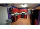 View of kitchen with red cabinets, black appliances, and wood floors at 20 Bacchus Dr, Lawrenceville, GA 30045