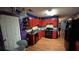 View of kitchen with red cabinets, wood floors, and black appliances at 20 Bacchus Dr, Lawrenceville, GA 30045