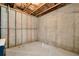 A large unfinished basement section with concrete walls and floor offers a blank canvas at 253 Orchard Trl, Holly Springs, GA 30115