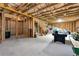 Large unfinished basement with framing, exposed insulation, and an air hockey table at 253 Orchard Trl, Holly Springs, GA 30115
