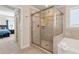 Modern bathroom showcases a glass-enclosed shower with tile accents, adjacent to the ensuite at 253 Orchard Trl, Holly Springs, GA 30115