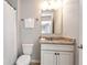 Bathroom features a vanity with a granite countertop, a toilet, and a shower with a white shower curtain at 253 Orchard Trl, Holly Springs, GA 30115