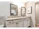 Elegant bathroom with double vanity sinks, granite countertops, and decorative mirrors at 253 Orchard Trl, Holly Springs, GA 30115