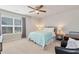 Bright bedroom featuring a cozy bed, window, and neutral tones for a peaceful and inviting space at 253 Orchard Trl, Holly Springs, GA 30115