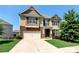 Charming two-story home with stone accents, a covered front porch, and a two-car garage at 253 Orchard Trl, Holly Springs, GA 30115