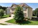 Well-maintained two-story home with manicured lawn, lush trees, and attractive landscaping at 253 Orchard Trl, Holly Springs, GA 30115