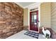 A close-up view of the front door with stone accents for a great curb appeal at 253 Orchard Trl, Holly Springs, GA 30115