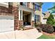 Charming front porch with stone accents and a well-manicured garden, providing a welcoming entrance at 253 Orchard Trl, Holly Springs, GA 30115
