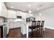 Well-appointed kitchen featuring white cabinetry, stainless steel appliances, and granite countertops at 253 Orchard Trl, Holly Springs, GA 30115