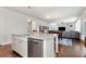 Granite kitchen island features stainless steel appliances and white cabinets at 253 Orchard Trl, Holly Springs, GA 30115