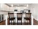 Bright kitchen boasts stainless steel appliances, a center island with barstool seating, and sleek white cabinets at 253 Orchard Trl, Holly Springs, GA 30115