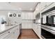 Modern kitchen with white cabinets, stainless steel appliances, and granite countertops at 253 Orchard Trl, Holly Springs, GA 30115