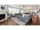 Open concept living room with a fireplace, dark hardwood floors, and a gray sectional sofa at 253 Orchard Trl, Holly Springs, GA 30115