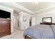 Bright main bedroom boasts a tray ceiling, ensuite bath access, and a large closet at 253 Orchard Trl, Holly Springs, GA 30115