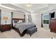 Spacious main bedroom features tray ceilings, plush carpet, a king bed, and lots of natural light at 253 Orchard Trl, Holly Springs, GA 30115