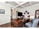 Beautiful office space featuring a large wooden desk, coffered ceilings, and hardwood floors at 253 Orchard Trl, Holly Springs, GA 30115