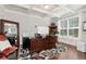 Bright office with a large window, a dark wood desk, and a coffered ceiling at 253 Orchard Trl, Holly Springs, GA 30115