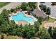 Aerial view of a community pool and recreation area with ample seating and a playground nearby at 253 Orchard Trl, Holly Springs, GA 30115