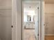 Large walk-in closet offering built-in shelving and a clear view of the ensuite bathroom at 253 Orchard Trl, Holly Springs, GA 30115