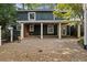 Exterior of home showcasing a covered patio and brick-paved driveway at 263 Mountainview Cir, Canton, GA 30115