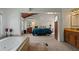 Spacious primary bathroom with a soaking tub and view of the bedroom, offering a relaxing and private retreat at 263 Mountainview Cir, Canton, GA 30115