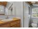 Quaint bathroom with bead board, wood vanity, and natural light at 263 Mountainview Cir, Canton, GA 30115