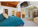 Spacious primary bedroom offering a view of the ensuite bathroom, with a wood ceiling and a comfortable bed at 263 Mountainview Cir, Canton, GA 30115
