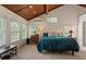 Serene bedroom with a wood ceiling, offering a restful retreat with plenty of natural light and a comfortable bed at 263 Mountainview Cir, Canton, GA 30115