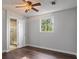 Inviting bedroom showcasing hardwood floors, a ceiling fan, and an ensuite bathroom at 263 Mountainview Cir, Canton, GA 30115