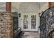 Close up of a home entrance with stone pillars, wrought iron details, and double doors at 263 Mountainview Cir, Canton, GA 30115