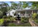 Charming white home with manicured landscaping and a fountain in the front yard at 263 Mountainview Cir, Canton, GA 30115