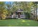 Charming single-story home featuring a well-manicured lawn and lush landscaping at 263 Mountainview Cir, Canton, GA 30115