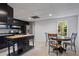 Open kitchen with black cabinets, a stainless steel refrigerator, and breakfast table at 263 Mountainview Cir, Canton, GA 30115