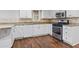 Charming kitchen with white cabinets, granite countertops, stainless steel appliances, and hardwood floors at 263 Mountainview Cir, Canton, GA 30115