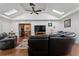 Open-concept living room with hardwood floors, ceiling fan, skylights, and large seating area at 263 Mountainview Cir, Canton, GA 30115