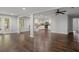 Spacious living room area with hardwood floors, ceiling fan, and ample lighting, adjacent to the kitchen and outdoor access at 263 Mountainview Cir, Canton, GA 30115