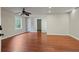 Hardwood floors complement the light paint, while a ceiling fan and bright window enhance this open living area at 263 Mountainview Cir, Canton, GA 30115