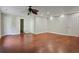 Spacious living room with hardwood floors, a ceiling fan, and fresh paint throughout at 263 Mountainview Cir, Canton, GA 30115