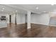 Open-concept living space featuring hardwood floors, white walls, and an eat-in kitchen area at 263 Mountainview Cir, Canton, GA 30115