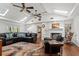 Spacious living room with wood floors, brick fireplace, built-in bookshelves, ceiling fans, and skylights at 263 Mountainview Cir, Canton, GA 30115
