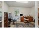 Office with large window for natural light, with desk, piano and cabinets at 263 Mountainview Cir, Canton, GA 30115