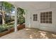 Outdoor patio featuring tiled flooring, white brick walls, and lush landscaping at 263 Mountainview Cir, Canton, GA 30115
