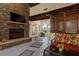 Inviting patio with a stone fireplace, tile floors, and comfortable seating area at 263 Mountainview Cir, Canton, GA 30115