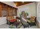 Relaxing sunroom with tile flooring, cushioned furniture, and a decorative dollhouse at 263 Mountainview Cir, Canton, GA 30115