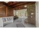 Inviting sunroom with stone fireplace, wood ceiling, and bench seating for relaxing and enjoying the outdoors at 263 Mountainview Cir, Canton, GA 30115