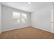 A basic bedroom featuring carpet floors, one window, and white walls at 342 Orwell Drive Lot 95, Social Circle, GA 30025