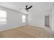 Light-filled bedroom features neutral carpet, natural light from large windows, and a ceiling fan for added comfort at 342 Orwell Drive Lot 95, Social Circle, GA 30025
