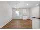 Bright dining area with wood floors, a modern chandelier, and white trim at 342 Orwell Drive Lot 95, Social Circle, GA 30025