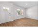 A bright entryway features wood-look floors and a white front door with sidelight windows at 342 Orwell Drive Lot 95, Social Circle, GA 30025