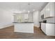 Well-lit kitchen features a center island with stainless steel appliances, white cabinets, and ample space for cooking at 342 Orwell Drive Lot 95, Social Circle, GA 30025